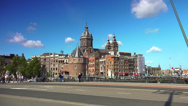 St Nicholas church, Bridge, streets, canals, buildings and boats in Amsterdam,Netherlands