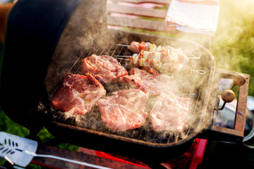 Juicy steamy stakes are being grilled on an old vintage grill.