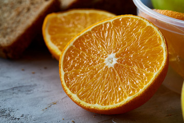 Fresh ripe orange halves on light grey background, selective focus