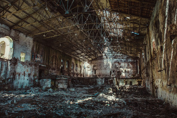 Fototapeta na wymiar Ruins of industrial building interior after disaster or war or earthquake, inside huge warehouse, pills of rubbish