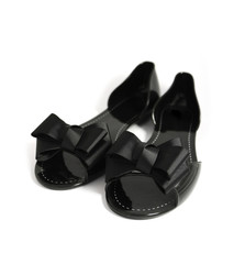 A pair of fancy stylish black woman summer shoe with ribbon bow, isolated on a white background.