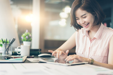 Beautiful woman Chatting and messaging on tablet and big smiling,Social network concept.Business woman Chatting and messaging work with tablet and she smiling.