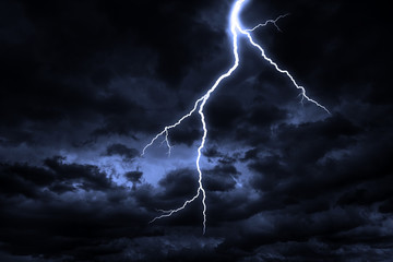 A lightning strike on a cloudy dramatic stormy sky.