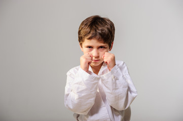 Portrait of a karate kid posing isolated on white background.