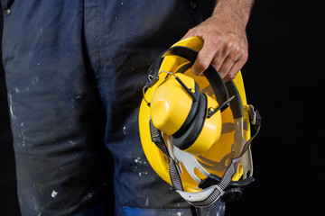 Helmet held by a construction worker. Protective clothing for manual workers.
