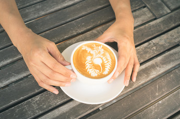 Woman drinking hot latte coffee.