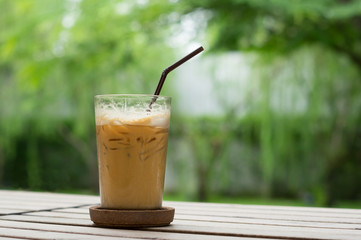 Iced coffee glass on wood table.