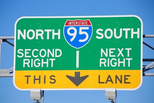 I-95 North South Second Right Next Right This Lane Green Yellow and Blue Sign in a Sunny Late Afternoon with Blue Sky