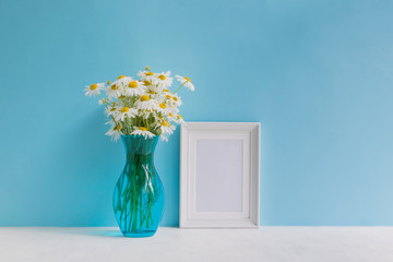 Mockup with a white frame and white daisies