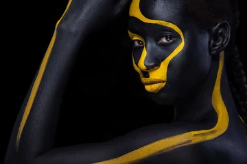 Wanddecoratie Zwart goud Cheerful young african woman with art fashion makeup. An amazing woman with black and yellow paint makeup  © Mike Orlov