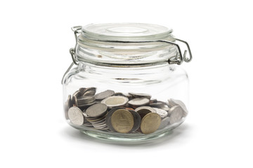 Coins in glass bottle on white background, investment and saving concept