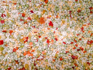 Mix of colorful tasty frosty vegetables. Mexican, Hawaiian mix. Corn, carrots, tomatoes, onion, green beans. Frozen vegetables concept