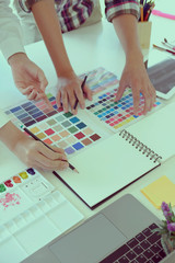 Fototapeta premium Two designer working with colour tone with computer at creative studio office.