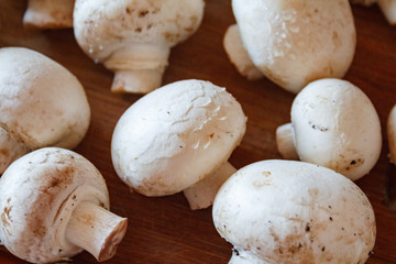 Champignon mushrooms, sacking mat and spices on wooden background