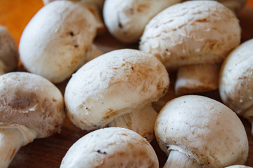 Champignon mushrooms, sacking mat and spices on wooden background