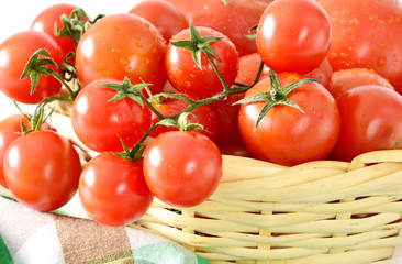 Many tomatoes in the basket.