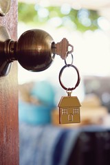 House key with home keyring in keyhole, property concept - 203796006