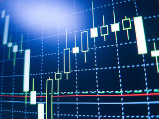 Abstract financial trading graphs on monitor. Background with currency bars and candles