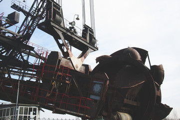 The huge coal mining machine captured with focus on mining wheel and structure in the front part of...