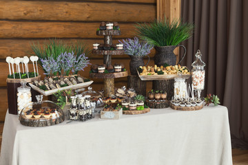 Dessert table for any holiday at wooden background