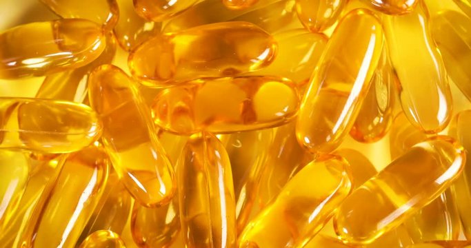 Rotation of a nutrition fish oil , rich of omega 3 supplement vitamin gel capsule , 4K Dci resolution