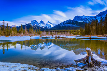 Three Sisters Mountain at Canmore, Alberta, Canada. This photo was taken during the transition between winter and snow season.