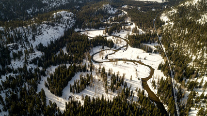Road leads along a meandering river near McCall Idaho in winter
