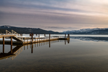 Fototapeta na wymiar Boat dock and reflection on an Idaho mountain lake in the morning