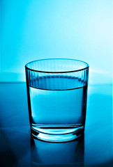 Refreshing drink of clear spring water in a glass on a white background