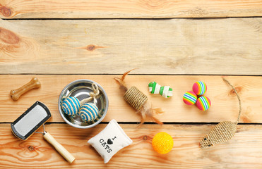 Flat lay composition with cat accessories on wooden background