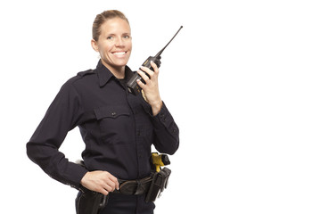 Smiling female police officer talking on walkie talkie