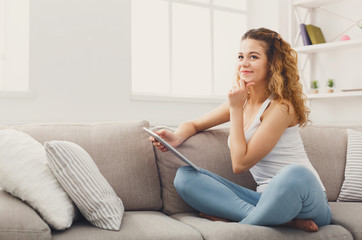 Obraz na płótnie Canvas Young redhead girl with digital tablet at home