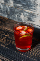 strawberry citrus lemonade on a dark background, vertical