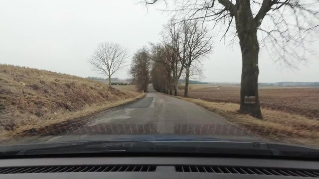Driving a car on a bumpy road, windshield view