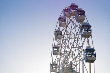 Ferris wheel on blue sky background with copy space