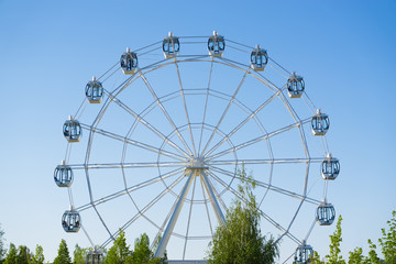Ferris wheel on blue sky background