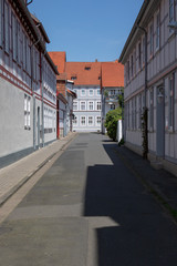 Fototapeta na wymiar View into a little street with frame work houses in a city in germany on a sunny day