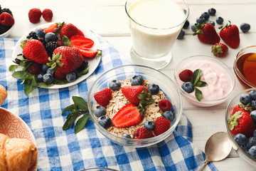 Rich breakfast on white wooden table