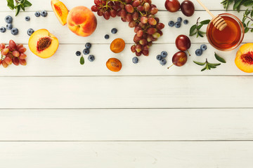 Assorted berries and fruits on white wooden table top view