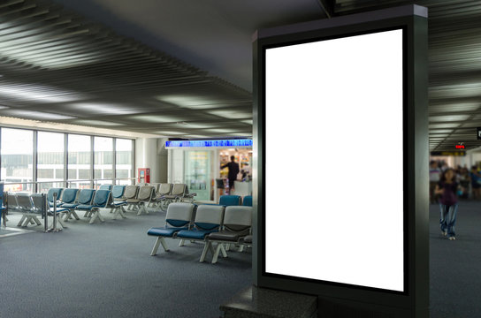 Mock Up Of Vertical Blank Advertising Billboard Or Light Box Showcase With People Waiting At Airport, Copy Space For Your Text Message Or Media Content, Advertisement, Commercial And Marketing Concept