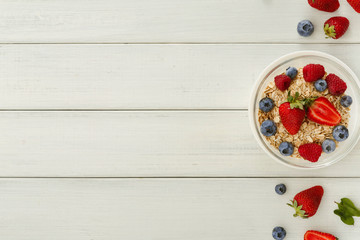 Healthy breakfast on white wooden table, top view