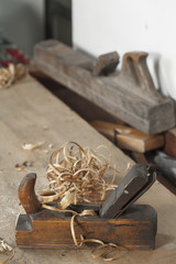 carpenter hand plane on wooden background