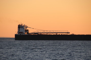 Ship on lake superior as the sun in setting
