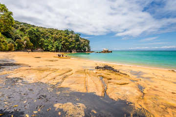 Abel Tasman National Park, New Zealand: Magical sandy beach with turquoise blue water on beautiful...