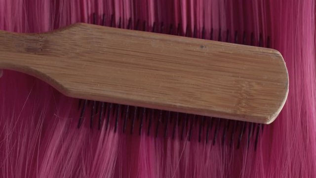 Closeup of pink hair creative colored texture. Pink hair combbing
