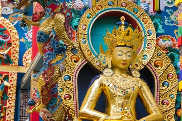Fototapeta na wymiar Buddha Amitayus golden statue at Namdroling Monastery in Bylakuppe, Karnataka, India. Tibetan Buddhist religion concept