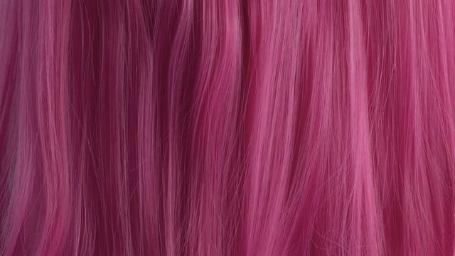 Closeup of pink hair creative colored texture tilt up camera movement showing pink hair texture
