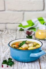 Swedish meatball soup in a pot on white rustic background. Selective focus, space for text.