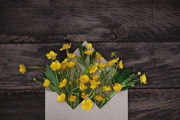 Yellow Little Flowers in Envelope Rustic Wooden Background Banner Flat Lay