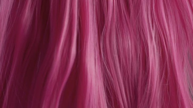 Closeup of pink hair creative colored texture Hair falling down from right and left side like a curtai in theatre